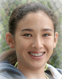 girl with braces at a softball field