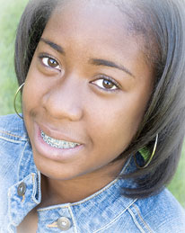 young african american girl with braces and smiling